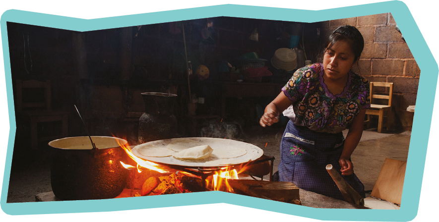 Zinacantan, Mexico - May 10, 2014: A traditional Mayan Tzotzil woman makes corn tortillas for tourists in her home in Zinacantan, Chiapas, Mexico.