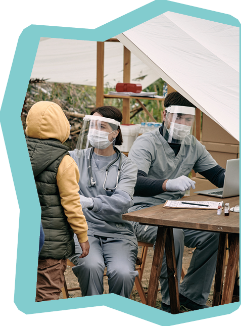 Medical specialists in protective masks sitting at table in tent and checking health of migrants standing in line