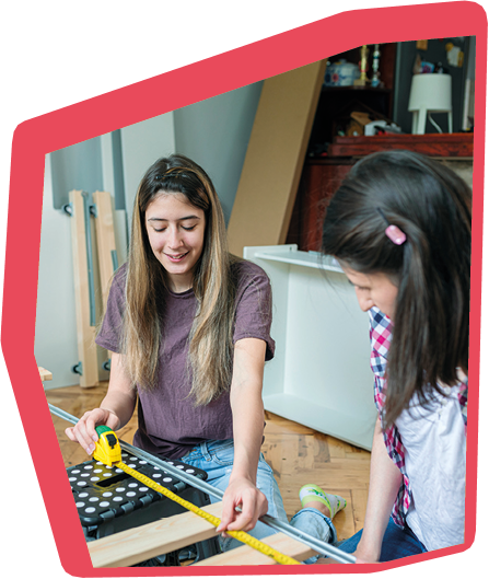 Beautiful and creative teenage girls assembling a bed in their room.