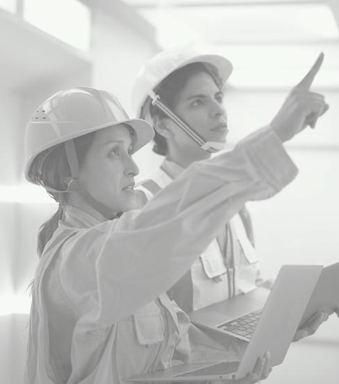 Senior worker person interacting with younger person. People reviewing instructions on a tablet, laptop. Represent Critical Infrastructure industries such as Energy & Utilities. Lifestyle imagery of general workers to represent Critical Infrastructure industries such as Energy & Utilities, City Public Works, Engineering and Manufacturing.