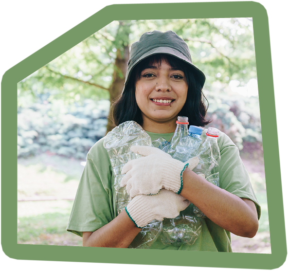 Portrait of a young volunteer woman recycling at the public park