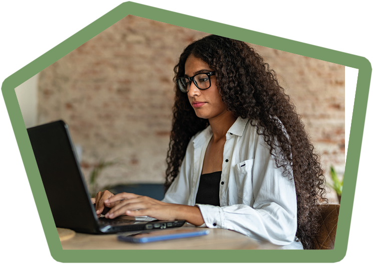 Young woman working (or studying) using laptop at home