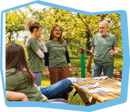 Group of volunteers including people with down syndrome taking a break in a rest area after a forest cleanup