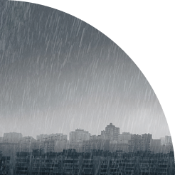 Dark moody rainy clouds over modern city skyline panorama. Wide angle.