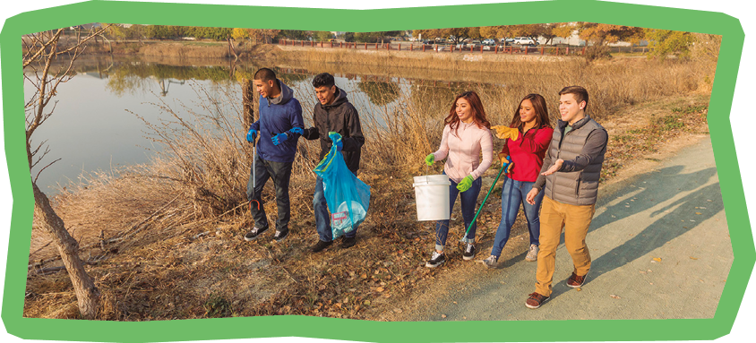 High quality stock photos of high school teens engaged in community service, picking up trash and cleaning up a local river and park.