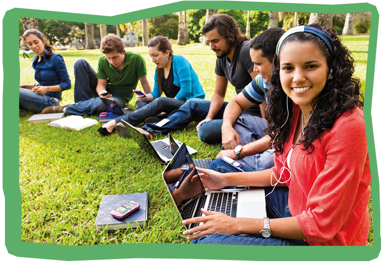 Group of students on the campus grass with laptops, mp3 music players and cellphones. The new technology era. 
