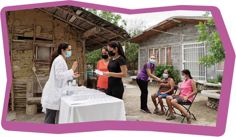 A female doctor and a nurse on a medical brigade with patients in a rural area.