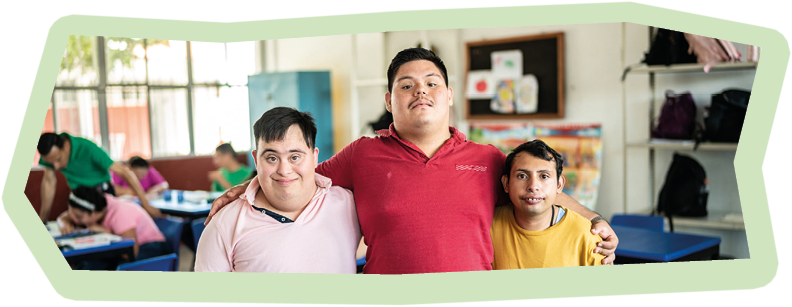 Portrait of students special needs embracing in the classroom at school