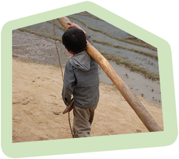 Poor little child is carring a trunk. I took this picture in North Vietnam in a hill tribe village near the border to China.