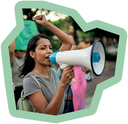 Young protester woman holding a sign on a protest outdoors