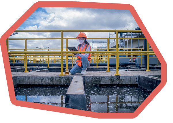 Worker take water from the wastewater treatment pond to check the quality of the water. After going through the wastewater treatment process,she wearing face mask to protect pollution.
