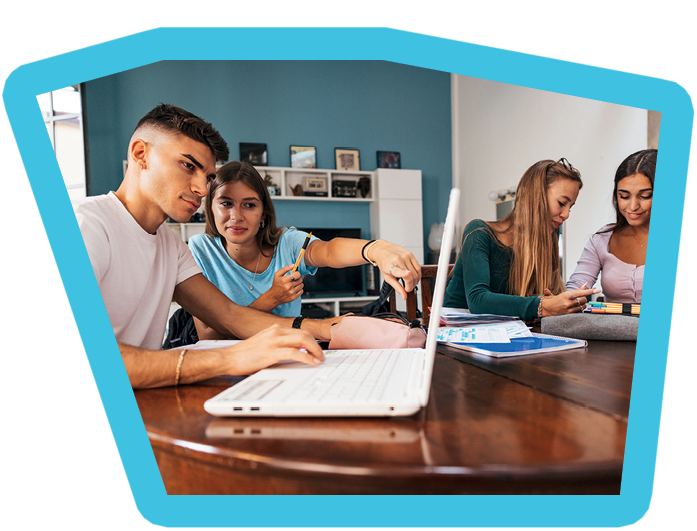Team of young college students teaming together at home using laptops and notebooks.