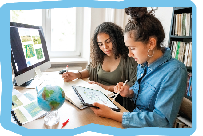 two young woman preparing together concepts for climate protection on desk indoors