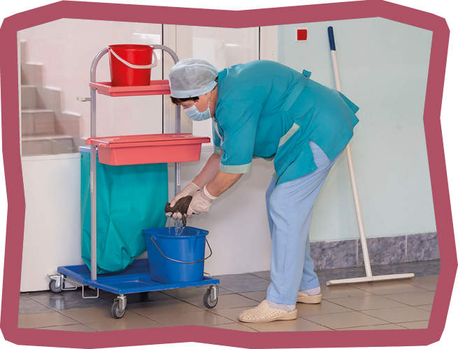 An adult female cleaner in uniform cleans the corridor of the hospital.