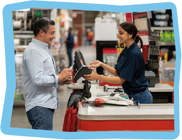 Portrait of a Latin American man paying by card at the cashier at a home improvement store