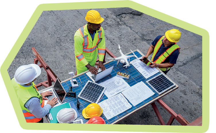 Portrait of team engineer working on solar panel and his blueprints with Solar photovoltaic equipment on construction site. Success teamwork
