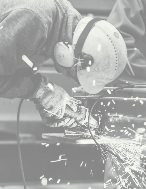 Worker grinding in a workshop. Heavy industry factory, metalwork