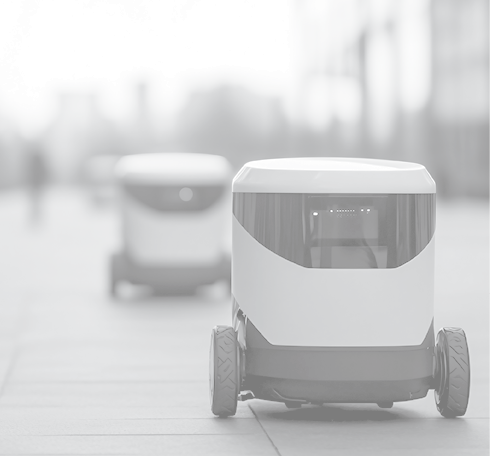 Self-driving delivery robots navigating an urban environment, illustrating advancements in automated delivery technologies and smart city logistics.