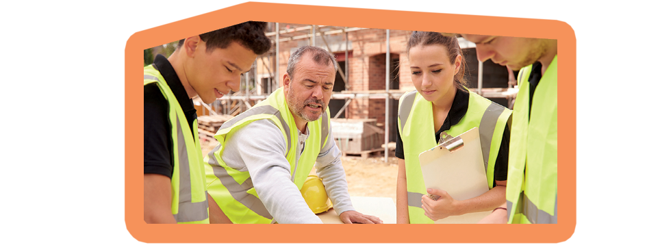 Builder On Building Site Discussing Work With Apprentice